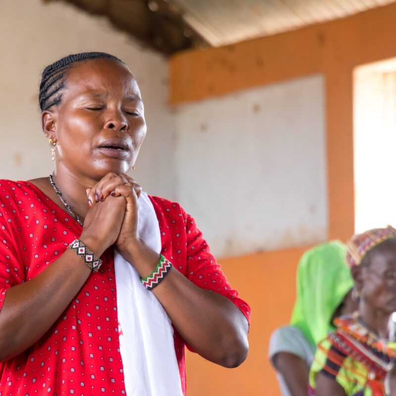 MAF - Women praying at church in LogLogo