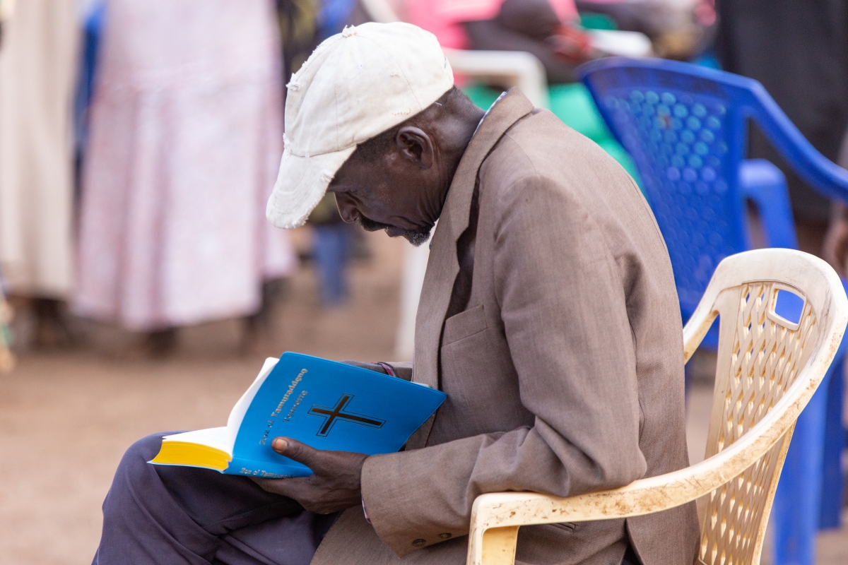 A Tennet man reading the New Testament in his own language for the 1st time