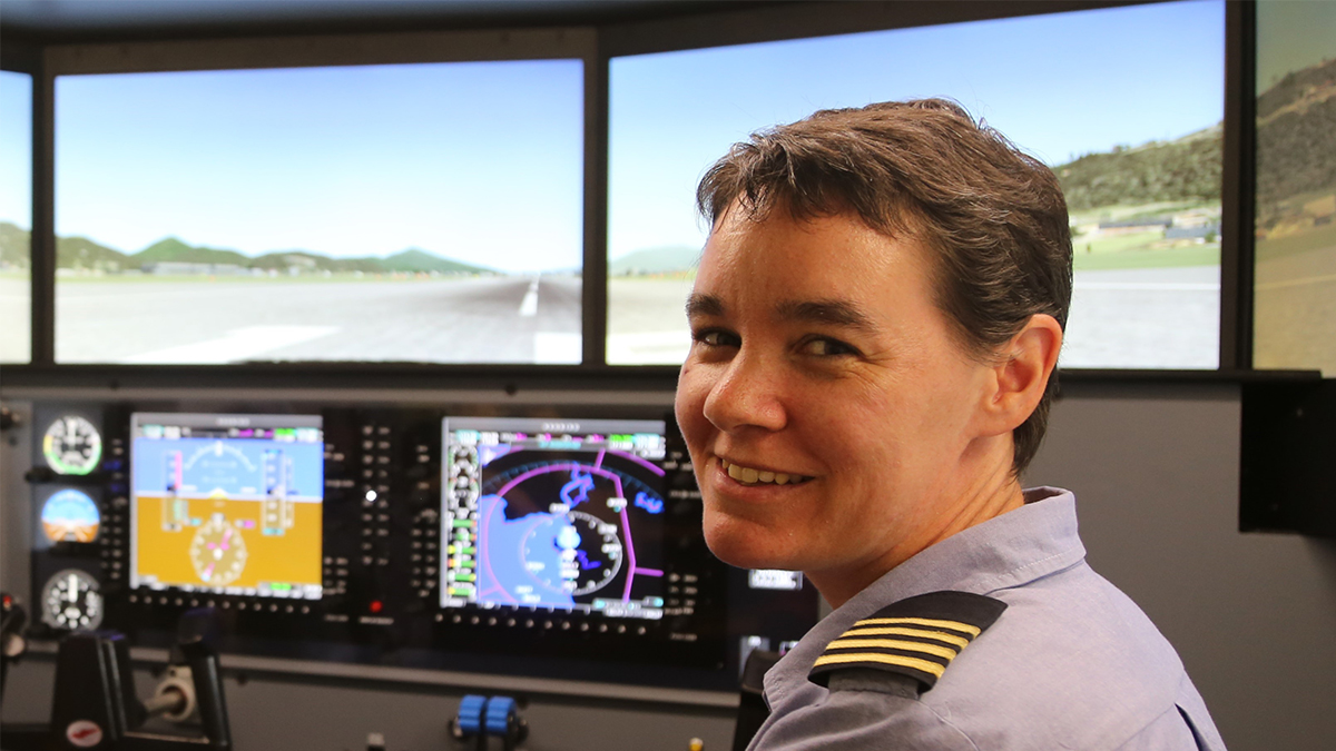 Bridget Ingham demonstrates how the Redbird flight simulator works at MAF Mareeba Flight Training Centre