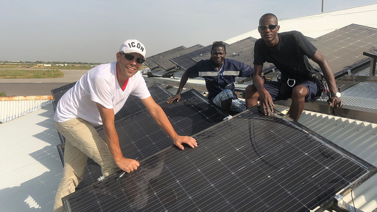 MAF Chad team (L to R: Henk, Tites and Arsene) install solar panels on the roof of the hangar