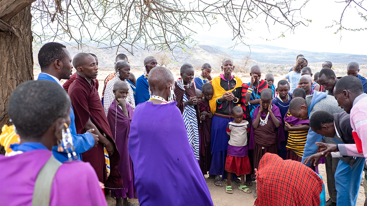Christians in the remote Maasai village of Merugoi pray after the evangelists land