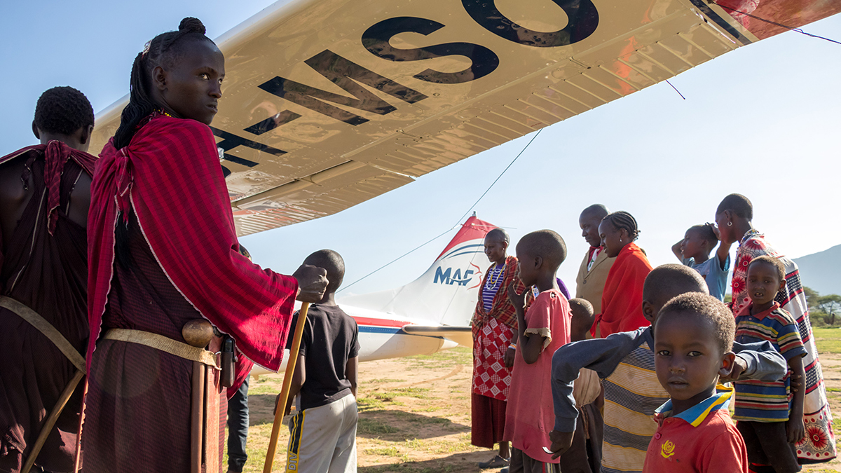 Maasai crowds often flock around the MAF plane after it lands