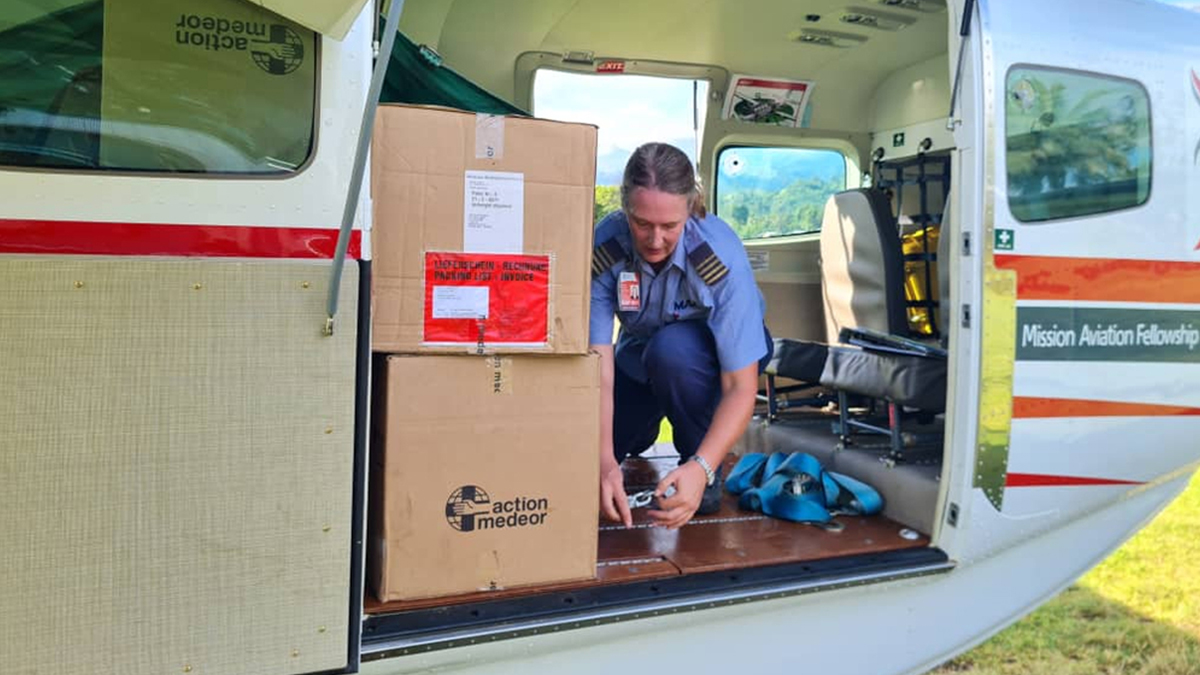 MAF pilot Glenys Watson unpacks lifesaving medical supplies