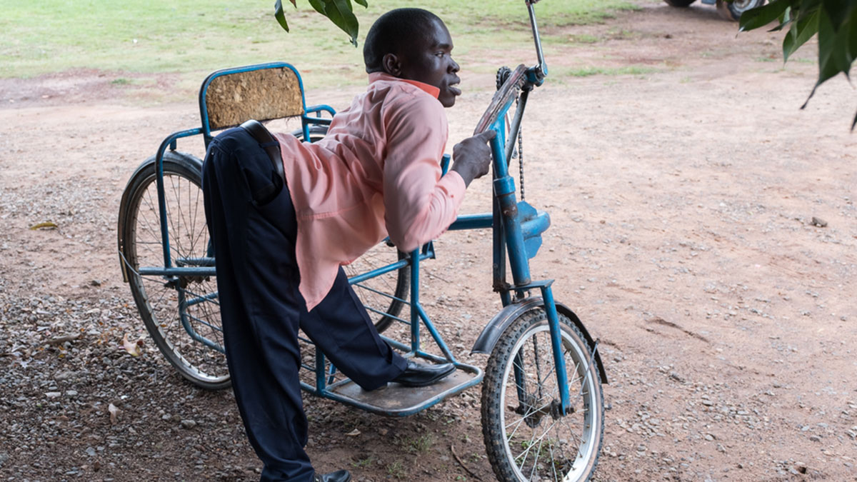 Jackson mounts his wheelchair in Uganda in 2017
