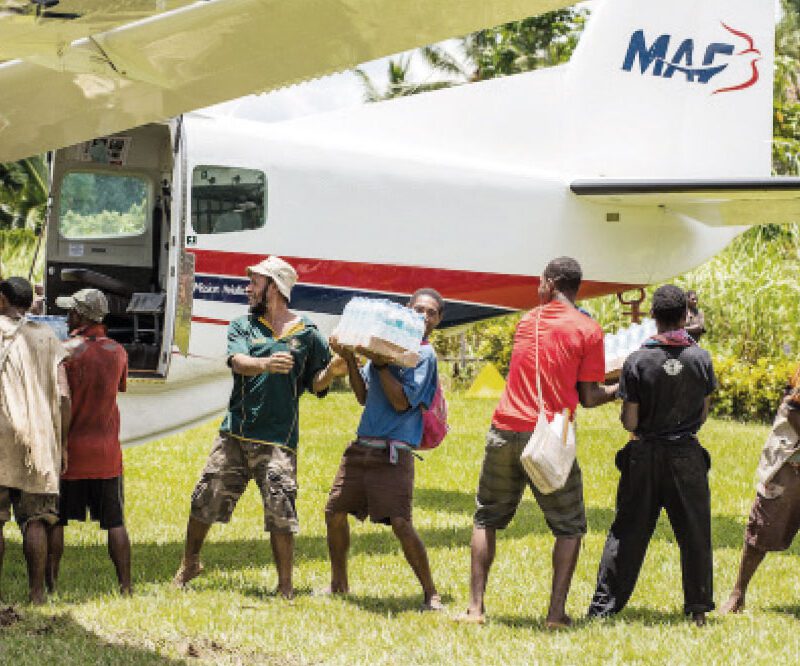 People unloading a MAF plane