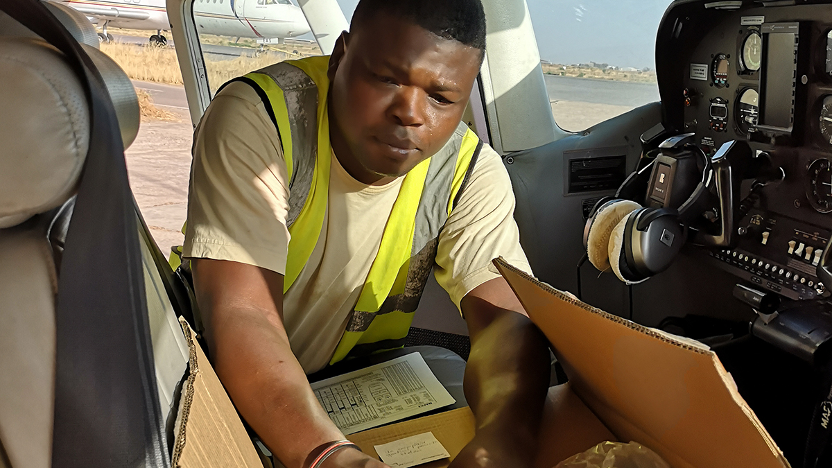 MAF Grounds Ops staffer, Dieudonne Mekambe, loading Bibles onto MAF aircraft