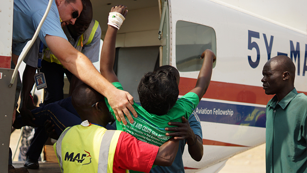 Unconscious of what is happening Manuela is lifted out of the plane and into a car at Juba International Airport.