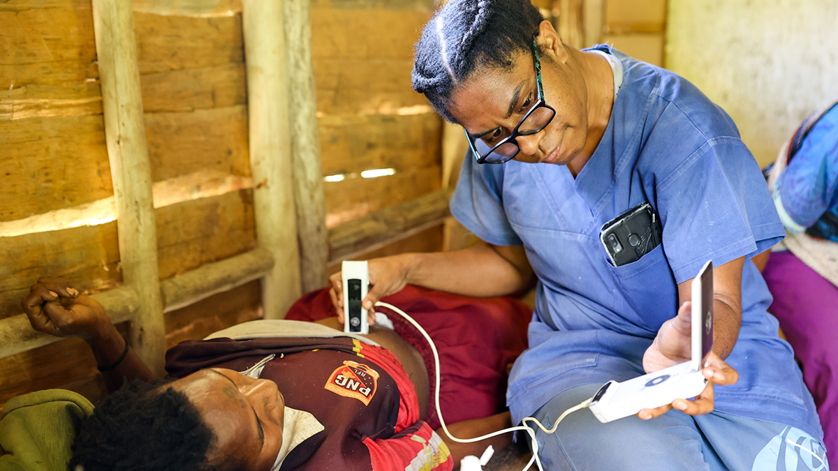 Dr Rebecca Williams giving a pregnant woman ultrasound in Malaumanda Village