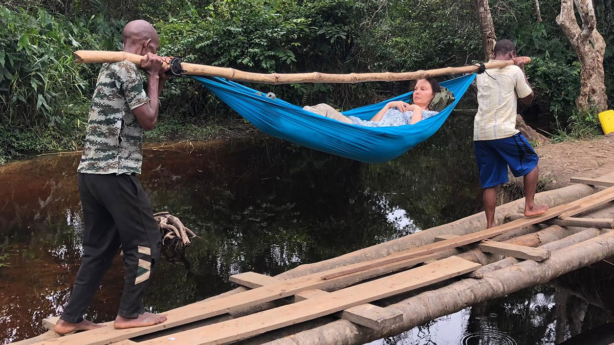 Ashley is carried out of the rainforest in a hammock over a series of rickety bridges 