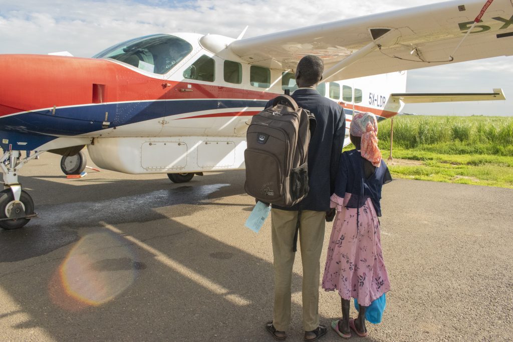 Grace*and her father Akech get ready to board MAF’s plane