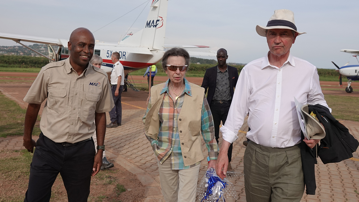 Sam Baguma, Finance Manager for East Africa (L) accompanies Princess Anne and Sir Tim Laurence off the MAF plane