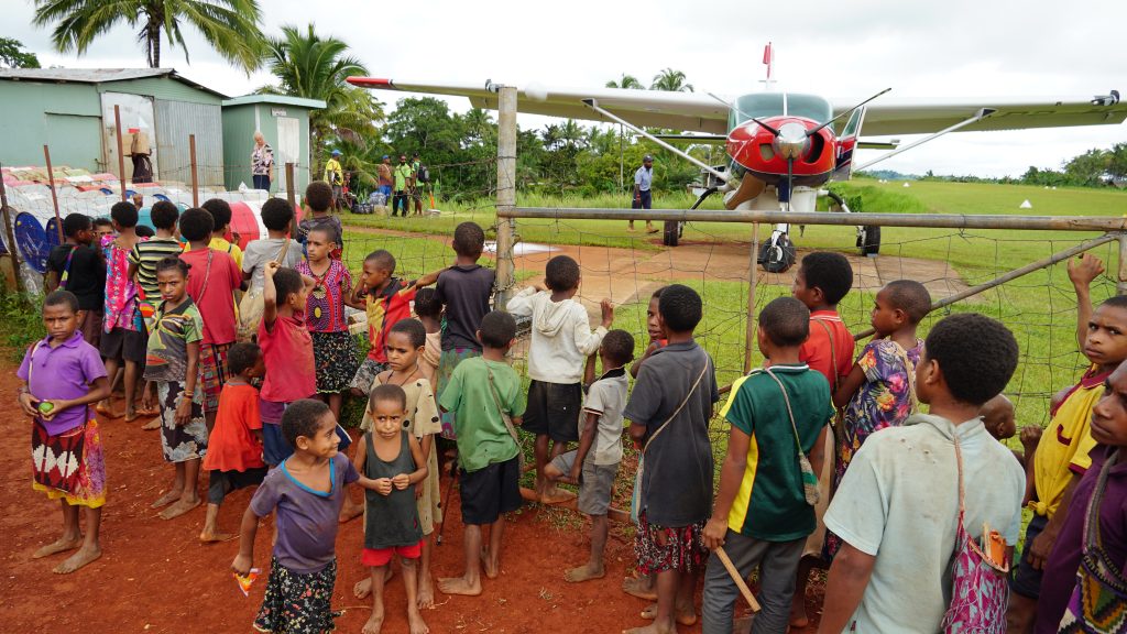 Girls and boys are in awe of the MAF plane but only half of the girls will go to secondary school
