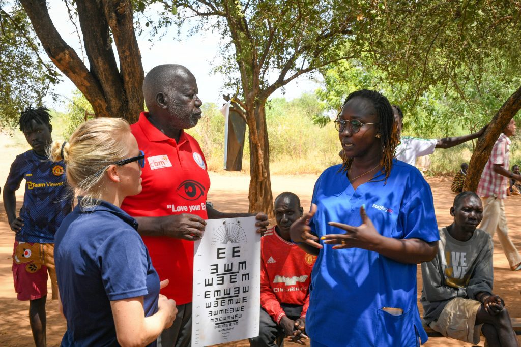 Dr Kuol (right) and team carry out eye tests in Loolim Village, Eastern Kapoeta (credit: Jenny Davies)