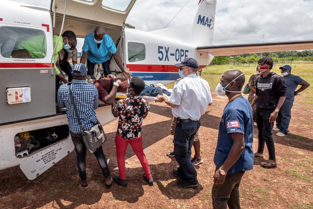 Ulrich loads a patient from Harper onto MAF plane destined for hospital in Monrovia (credit: Dave Forney)