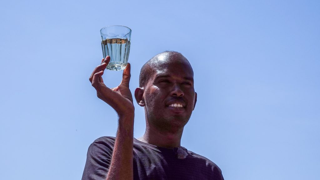 Meshack Gayere celebrates with a glass of clean water! (credit: Paula Alderblad)
